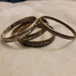 Brass & silver bangle bracelets with heart cutout.
